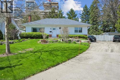 White exterior residence with a gray shingled roof and front landscaping - 2117 Edinburgh Drive, Burlington, ON - Outdoor