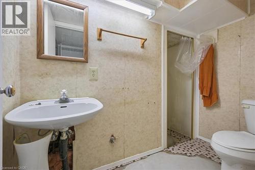 Bathroom featuring a wall-mounted sink, framed mirror, and a shower enclosure - 2117 Edinburgh Drive, Burlington, ON - Indoor Photo Showing Bathroom