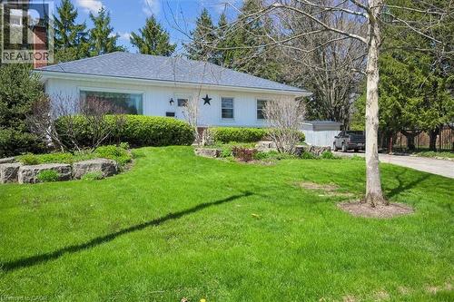 Classic ranch-style residence featuring a white exterior with a blue shingle roof - 2117 Edinburgh Drive, Burlington, ON - Outdoor