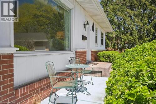 Exterior with white siding and brick detailing, featuring a prominent picture window - 2117 Edinburgh Drive, Burlington, ON - Outdoor