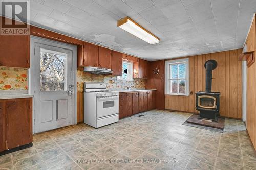 Kitchen w/wood stove & door to outside - 2421 Buckwheat Road W, Edwardsburgh/Cardinal, ON 