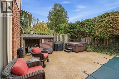 Hot tub, grilling and seating area by pool and pool equipment storage - 668 Tomahawk Crescent, Ancaster, ON - Outdoor With Deck Patio Veranda With Exterior