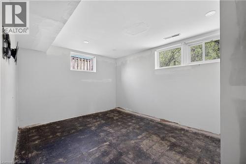 Lower level room featuring recessed lighting, a window, and a second window with security bars - 515 Bobbybrook Drive, London, ON - Indoor Photo Showing Other Room