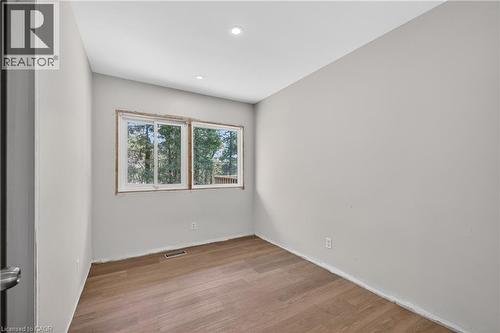 Room with light gray walls, wood-finish flooring, and recessed ceiling lighting - 515 Bobbybrook Drive, London, ON - Indoor Photo Showing Other Room