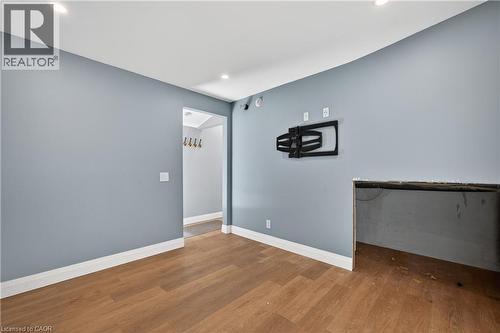 Interior space featuring wood-finish flooring, light blue walls, and white baseboards - 515 Bobbybrook Drive, London, ON - Indoor Photo Showing Other Room