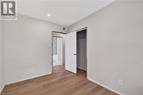Interior room with wood-finish flooring and light gray walls - 515 Bobbybrook Drive, London, ON - Indoor Photo Showing Other Room