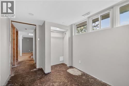 Room featuring three transom windows, a recessed closet area with hanging rod, and partially finished walls - 515 Bobbybrook Drive, London, ON - Indoor Photo Showing Other Room