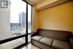Floor-to-ceiling window framing urban structures - 
