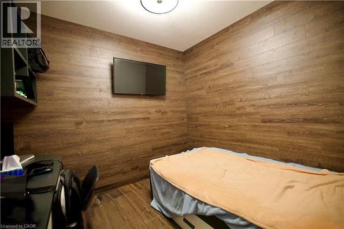 Room featuring wood-finish wall panels and coordinating wood-finish flooring - 330 Phillip Street Unit# S605, Waterloo, ON - Indoor Photo Showing Other Room