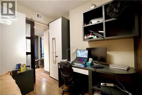 Dedicated workspace featuring wood-finish flooring and neutral wall tones - 330 Phillip Street Unit# S605, Waterloo, ON - Indoor Photo Showing Office