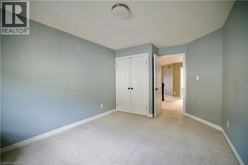 Room featuring light gray wall paint, white baseboards, and light-colored carpet flooring - 711 Cedar Bend Drive, Waterloo, ON - Indoor Photo Showing Other Room