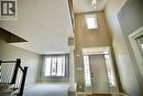 Two-story foyer with transom window and sidelights, featuring a prominent column and a decorative pendant light fixture - 711 Cedar Bend Drive, Waterloo, ON  - Indoor Photo Showing Other Room 