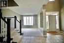 Two-story foyer with ceramic tile flooring, a prominent decorative column, and a front entry door with transom and sidelight windows - 711 Cedar Bend Drive, Waterloo, ON  - Indoor Photo Showing Other Room 