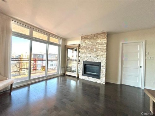 Living Room - 711-2160 Av. Terry-Fox, Laval (Chomedey), QC - Indoor Photo Showing Living Room With Fireplace