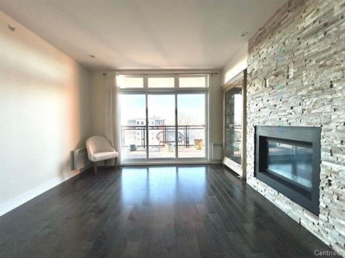 Living Room - 711-2160 Av. Terry-Fox, Laval (Chomedey), QC - Indoor Photo Showing Living Room With Fireplace