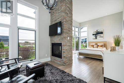 Main floor primary bedroom with 2 sided fireplace - 1 Windrose Valley Boulevard, Clearview, ON - Indoor Photo Showing Other Room With Fireplace