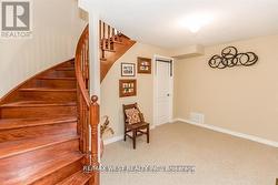 CUSTOM OAK STAIRS OPEN TO BASEMENT LANDING. - 