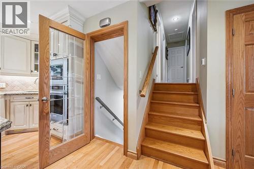 Staircase featuring wood-finish treads and risers with a matching wood-finish handrail - 574 Sprucehill Avenue, Waterloo, ON - Indoor Photo Showing Other Room