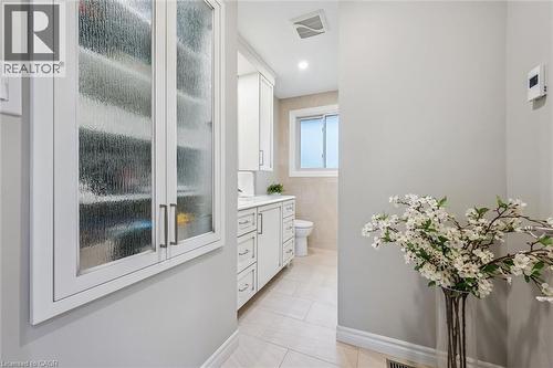 Recessed built-in cabinetry with reeded glass doors - 574 Sprucehill Avenue, Waterloo, ON - Indoor Photo Showing Other Room