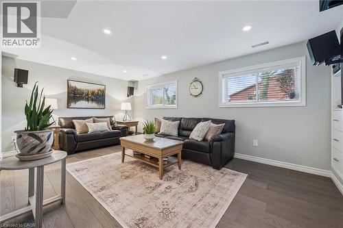 Spacious living area featuring wood-finish flooring, recessed lighting, and multiple windows with blinds - 574 Sprucehill Avenue, Waterloo, ON - Indoor Photo Showing Living Room