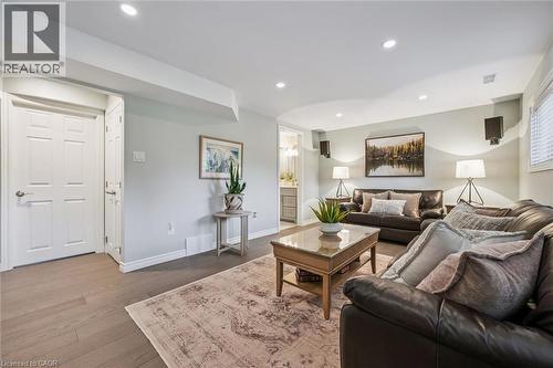 Spacious living area featuring wood-finish flooring, recessed lighting, and a neutral wall color - 574 Sprucehill Avenue, Waterloo, ON - Indoor Photo Showing Living Room