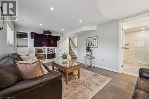 Entertainment area featuring wood-finish flooring, recessed lighting, and a built-in media center with shelving - 574 Sprucehill Avenue, Waterloo, ON - Indoor Photo Showing Living Room