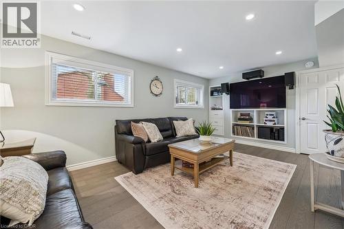 Recessed lighting illuminates the wood-finish flooring and light-toned walls - 574 Sprucehill Avenue, Waterloo, ON - Indoor Photo Showing Living Room