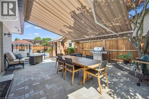 Paver patio with a retractable awning providing extensive coverage - 574 Sprucehill Avenue, Waterloo, ON - Outdoor With Deck Patio Veranda With Exterior