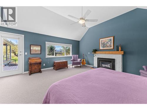 Primary Suite - 3990 June Springs Road, Kelowna, BC - Indoor Photo Showing Bedroom With Fireplace
