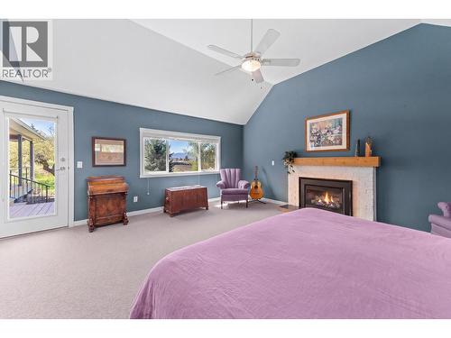 3990 June Springs Road, Kelowna, BC - Indoor Photo Showing Bedroom With Fireplace