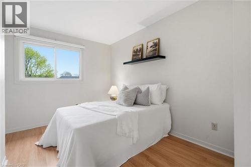 Bedroom featuring light wood-finish flooring, white walls, and a large window - 56 Angela Crescent, Cambridge, ON - Indoor Photo Showing Bedroom