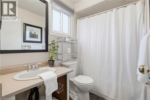 Main bathroom featuring a vanity with a drop-in sink, a window, a toilet, a full-size mirror, and a shower area - 56 Angela Crescent, Cambridge, ON - Indoor Photo Showing Bathroom
