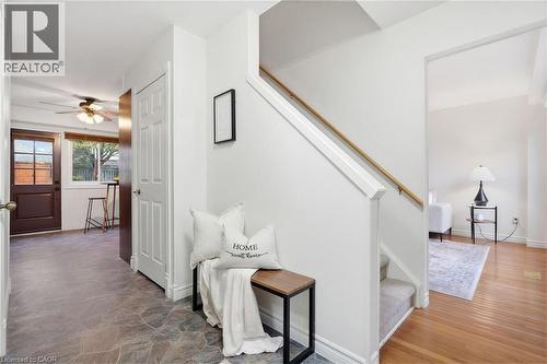Entryway featuring a staircase with wood handrail, white risers, and carpeted treads - 56 Angela Crescent, Cambridge, ON - Indoor Photo Showing Other Room