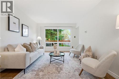 Living area featuring wood-finish flooring and a large window - 56 Angela Crescent, Cambridge, ON - Indoor Photo Showing Living Room