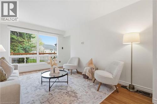 Bright living space featuring expansive windows, and wood-finish flooring - 56 Angela Crescent, Cambridge, ON - Indoor Photo Showing Living Room