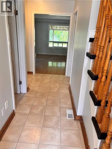 Tiled entry flooring with wood-finish baseboards - 206 Northmanor Crescent, Kitchener, ON 