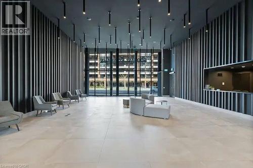 Spacious lobby featuring floor-to-ceiling windows, light-toned tile flooring, contemporary slat wall design, integrated ceiling lighting, and a reception desk with matching slat detailing - 500 Wilson Avenue Unit# 614, Toronto, ON - Indoor Photo Showing Other Room