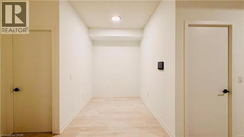 Hallway featuring light wood-finish flooring, white walls, and recessed lighting - 4878 Powers Common Unit# 301, Burlington, ON - Indoor Photo Showing Other Room