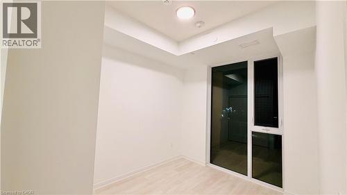 Expansive window wall with white framing - 4878 Powers Common Unit# 301, Burlington, ON - Indoor Photo Showing Other Room