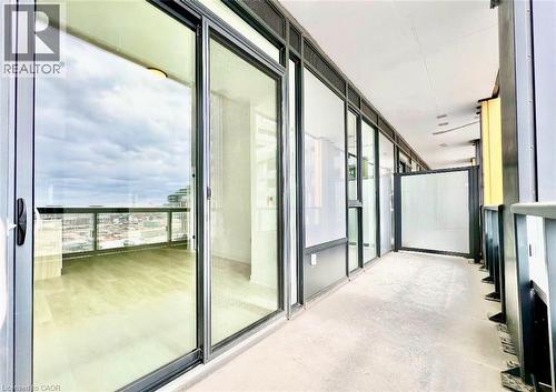 Expansive balcony featuring concrete flooring and a glass railing - 4878 Powers Common Unit# 301, Burlington, ON -  With Balcony With Exterior