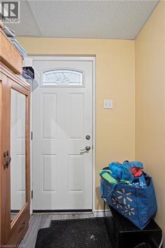 White entry door with decorative glass panel and satin nickel hardware - 179 Vancouver Street, London, ON - Indoor Photo Showing Other Room