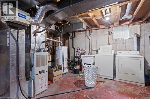 Basement utility area featuring a forced-air furnace, hot water heater, and laundry hookups - 179 Vancouver Street, London, ON - Indoor Photo Showing Laundry Room