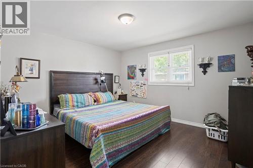 Bedroom featuring wood-finish flooring and a central window with blinds - 179 Vancouver Street, London, ON - Indoor Photo Showing Bedroom