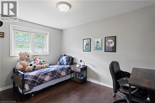 Bright room featuring wood-finish flooring, a white trim window, and neutral wall tones - 179 Vancouver Street, London, ON - Indoor Photo Showing Bedroom