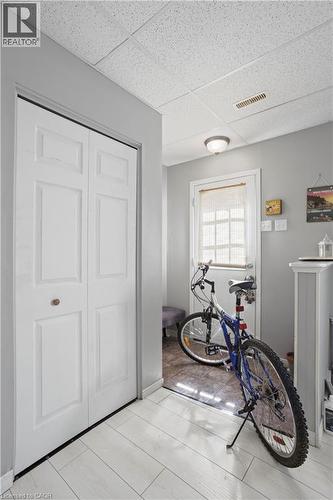 Entryway featuring light-toned wood-finish flooring, a bi-fold closet, and neutral gray wall paint - 179 Vancouver Street, London, ON - Indoor Photo Showing Other Room