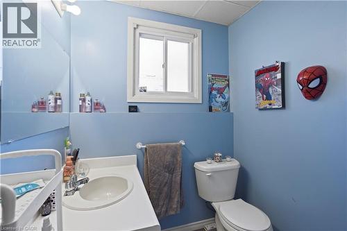Bathroom featuring a vanity with an integrated sink, a toilet, a window, and a wall-mounted mirror - 179 Vancouver Street, London, ON - Indoor Photo Showing Bathroom