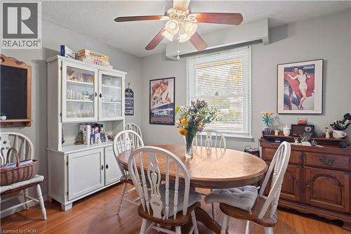 Dining area featuring wood-finish flooring, a ceiling fan with light fixture, light gray wall paint, and a window with blinds - 179 Vancouver Street, London, ON - Indoor Photo Showing Dining Room