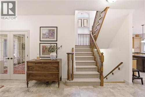 Carpeted staircase with wood handrails and balusters - 129 Magnificent Way, Binbrook, ON - Indoor Photo Showing Other Room