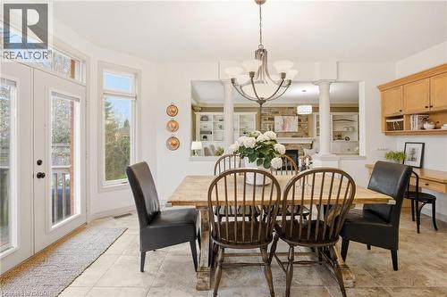 Dining area featuring neutral-toned tile flooring, a multi-pane glass door, and a multi-pane window - 129 Magnificent Way, Binbrook, ON - Indoor Photo Showing Dining Room