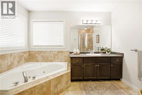 Corner soaking tub with tiled surround - 129 Magnificent Way, Binbrook, ON - Indoor Photo Showing Bathroom